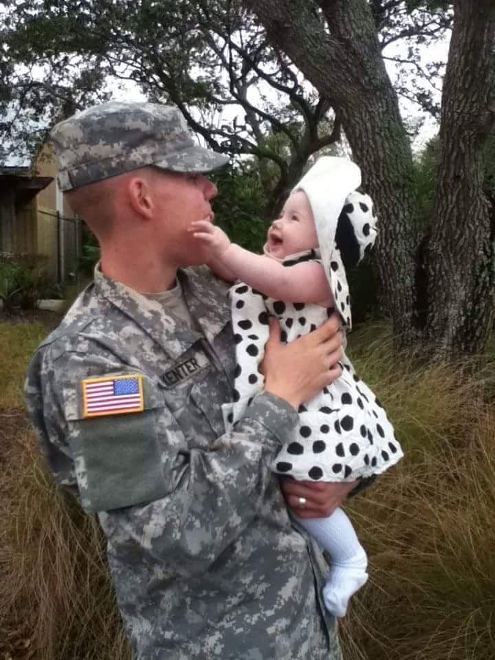 Soldier holding young daughter